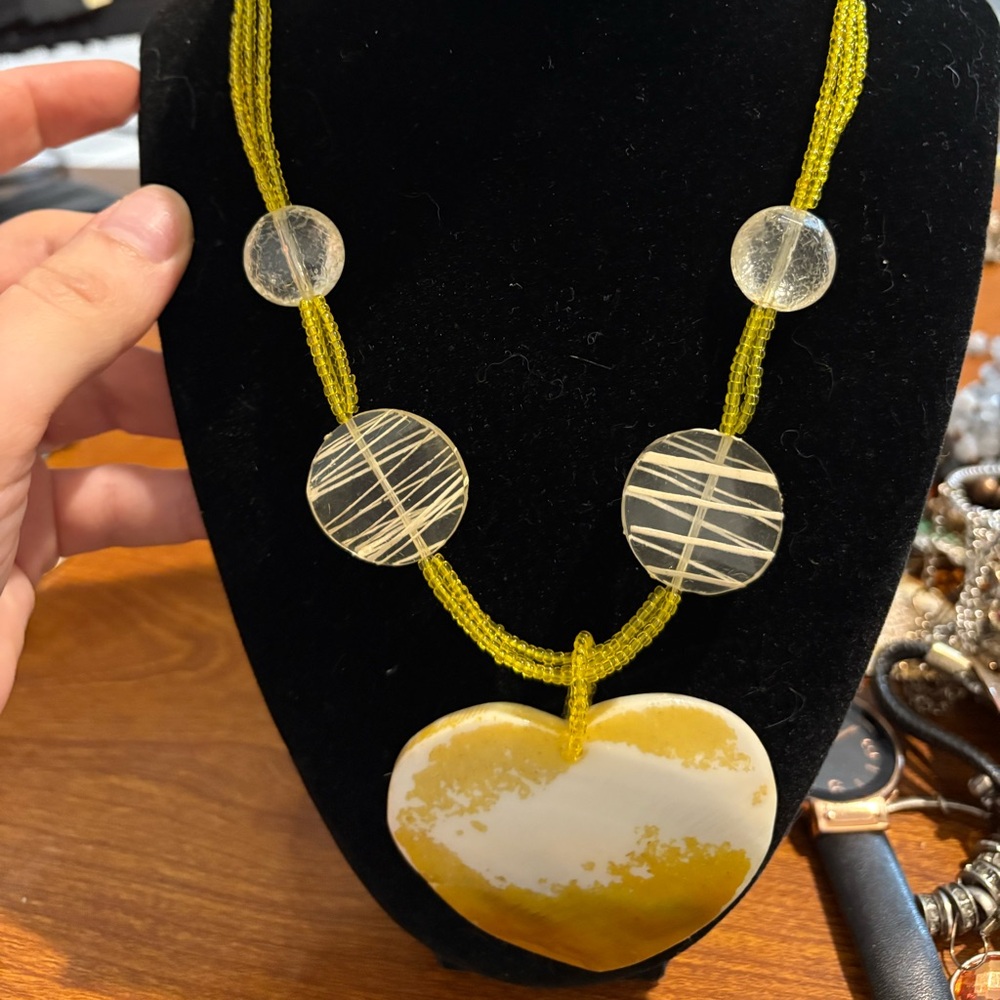 yellow beaded statement necklace featuring a large heart-shaped pendant